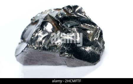 Shungit is a black rock that consists mainly of carbon and was photographed in top quality and studio quality. Stock Photo