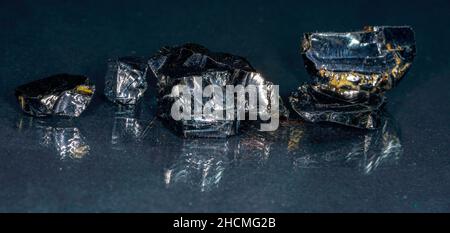 Shungit is a black rock that consists mainly of carbon and was photographed in top quality and studio quality. Stock Photo