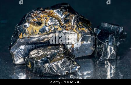 Shungit is a black rock that consists mainly of carbon and was photographed in top quality and studio quality. Stock Photo