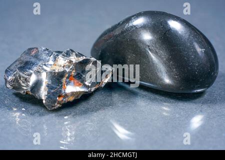 Shungit is a black rock that consists mainly of carbon and was photographed in top quality and studio quality. Stock Photo