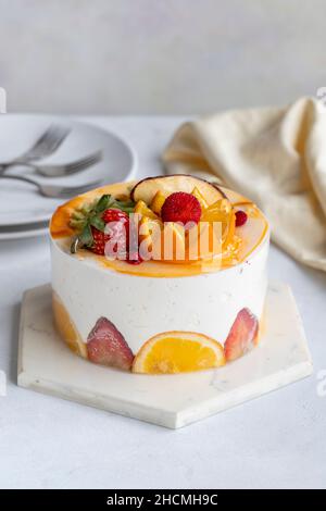 Fruit Parfait Cake on a white background. Fruit cake with white cream. Close-up. Vertical view Stock Photo
