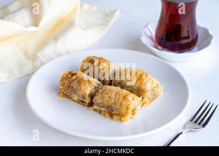 Walnuts baklava on a white plate. Turkish cuisine flavor baklava. Horizontal view. Stock Photo