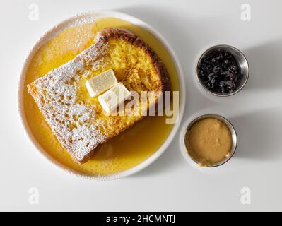 Butter melting on fresh piece of bread Stock Photo