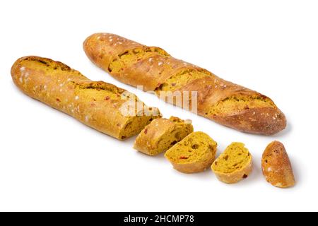 Fresh baked homemade baguette and slices with curry and tomato seasoning isolated on white background Stock Photo