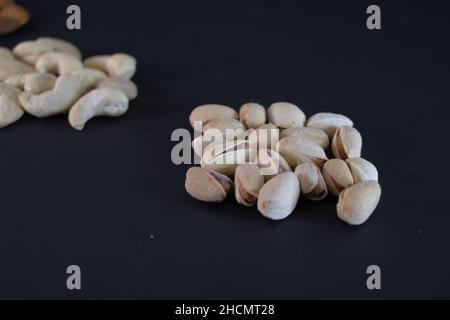 Portion of salted open pistachios on a beautiful background. High-quality background. Copy space Stock Photo