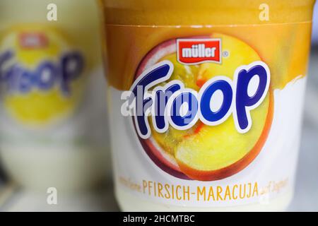 Viersen, Germany - December 9. 2021: Closeup of label on plastic cup with logo lettering of muller froop fruit yoghurt desert Stock Photo