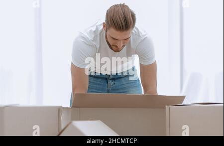 male sorting things in the new apartment. Stock Photo