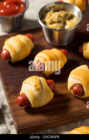 Homemade Pigs in a Blanket with Mustard and Ketchup Stock Photo