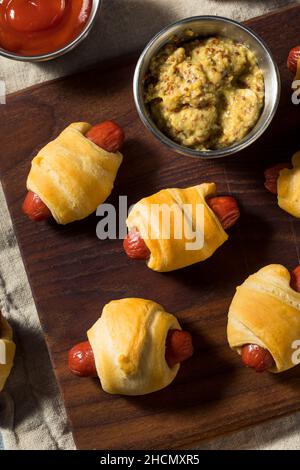 Homemade Pigs in a Blanket with Mustard and Ketchup Stock Photo