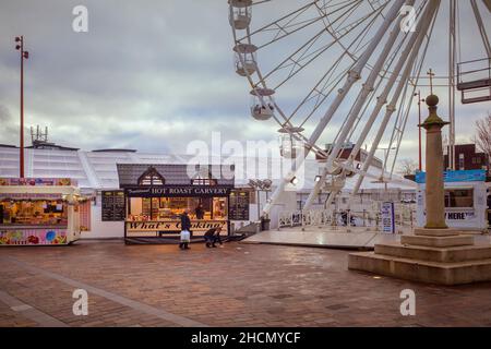 The Christmas Wheel of Light and street food vendors make a festive appearance in Jubilee Square. The High Cross monument can also be seen. Stock Photo