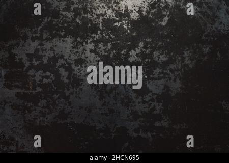 Rough, dark metal background lit by spotlight background Stock Photo