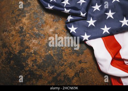 American flag on dark rusty metal with free space. 4th July Veterans or US Independence day. Stock Photo