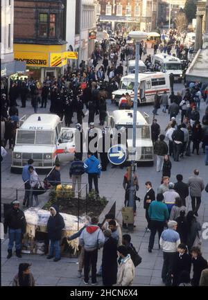 Police officers and groups of youths in Dudley Street Wolverhampton following the death of Clinton McCurbin who died from asphyxia while being arrested for alledged shoplifting and use of a stolen credit card in Wolverhampton, West Midlands, England. Stock Photo