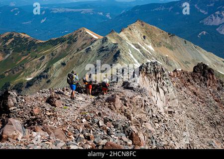 WA19948-00...WASHINGTON - Pacific Crest Trail thru-hikers heading north from the Goat Rocks towards White Pass in the Goat Rocks Wilderness area. Stock Photo