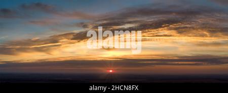 Panorama of sunrise with red rays from behind the clouds. Blurred sky and abstract orange clouds Stock Photo