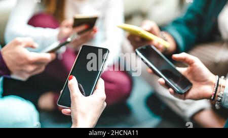 Closeup of blogger hands using data on mobile smartphones - Detail of friends sharing images on social media with smart phones Stock Photo