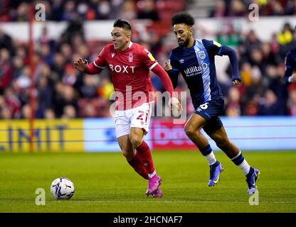 Nottingham Forest's Braian Ojeda (left) and Huddersfield Town's Sorba Thomas battle for the ball during the Sky Bet Championship match at the City Ground, Nottingham. Picture date: Thursday December 30, 2021. Stock Photo