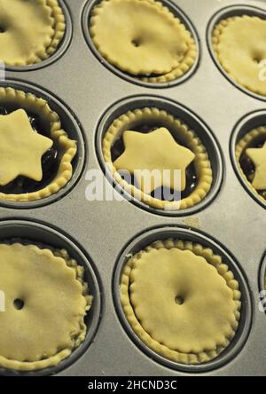 Homemade, deep filled mince pies ready to be baked in the tray Stock Photo