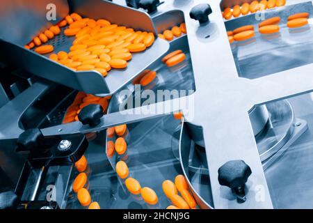 Pharmaceutical production line, production of tablets or vitamins manufacturing, tablet conveyor Stock Photo