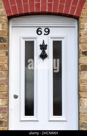 House number 69 beneath a brick arch Stock Photo