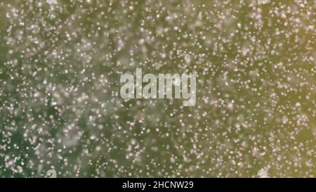 Multi colored powder flying in slow motion as camera pulls away and rotates. Slow motion macro shot of dust float in air for overlay. Stock Photo