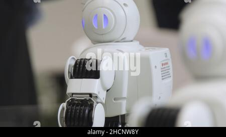SHANGHAI - JUNE 28 2018: A small robot with human face and body - humanoid. Closeup of an cute autonomous service robot. Close-up of robot head. Stock Photo