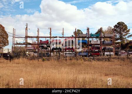 Old pickup truck beds stacked in a used car parts yard or junkyard in rural Alabama, USA. Stock Photo