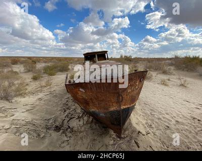 Mujnak, Uzbekistan. 21st Oct, 2021. A rusty ship stands in the sand of the former port city from which the water retreated decades ago. The salt and sand desert of Aralkum continues to grow. The region is considered the biggest ecological disaster on earth. (to the KORR report 'Eco-disaster Aral Sea: The fight for its remains continues') Credit: Ulf Mauder/dpa/Alamy Live News Stock Photo