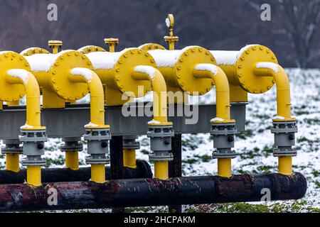 Yellow gas infrastructure elements sticking out of the ground. Winter photo of a snow-covered gas pipeline. High natural gas prices. The photo was tak Stock Photo