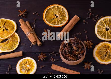 Top view Dried orange slice, cinnamon sticks and anise on wooden background. Traditional christmas composition. Flat lay Stock Photo