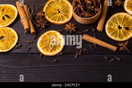 Top view Dried orange slice, cinnamon sticks and anise on wooden background. Traditional christmas composition. Flat lay Stock Photo