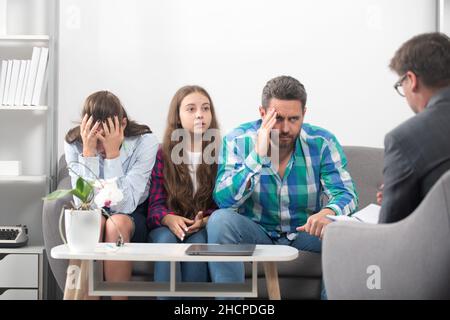 Family at psychology session. Psychological parents problem. Social worker psychologist talking to father mother and daughter teenage girl Stock Photo