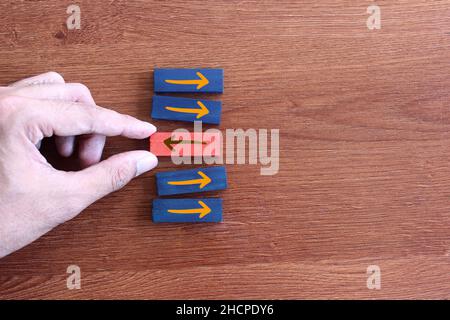 Top view image of arrow sign in opposite direction from others. Unique, think different, individual and standing out from the crowd concept. Stock Photo