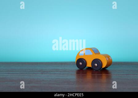 Close up image of wooden toy car with copy space for text. Blue background Stock Photo