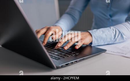 Female hands typing on laptop Stock Photo