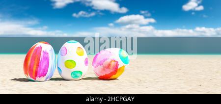 beach with colorful easter eggs during a easter vacation at the beach Stock Photo