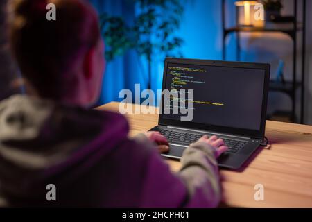 Woman using laptop for coding Stock Photo
