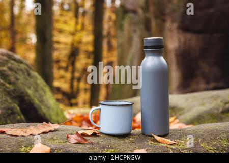 small steel thermos bottle and hot tea on a rock during cold season hiking  Stock Photo - Alamy