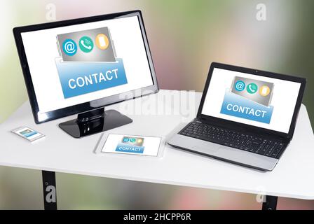 Contact concept shown on different information technology devices Stock Photo