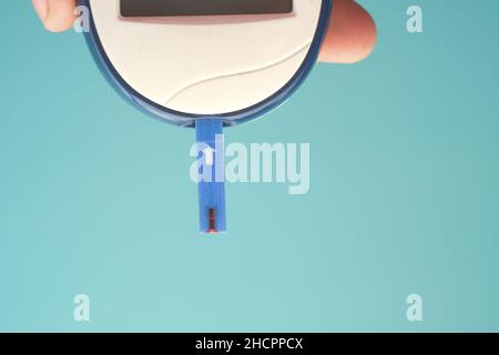 holding measuring blood sugar level top view  Stock Photo