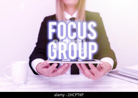 Handwriting text Focus Group. Business overview consist of carefullyselected participants to provide feedback App Developer Presenting New Program Stock Photo