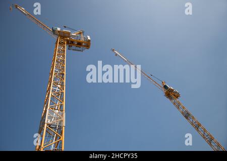 Two cranes working in tandem on a construction site in the UK Stock Photo