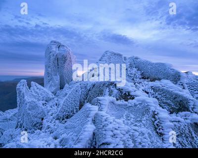 The summit of Red Screes covered by hoar frost at dawn Lake District UK. Stock Photo