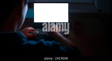 Man is working on a laptop at night. Stock Photo