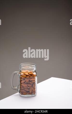 Glass jar filled with a variety of nutrition and healthy snacks and nuts on a dark background Stock Photo