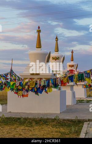Stupas and flags near Syakusn Syume, Geden Sheddup Choikorling Monastery, Tibetan Buddhist monastery in Elista, Republic of Kalmykia, Russia Stock Photo