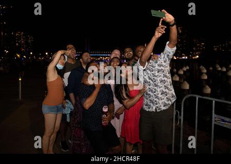 Melbourne, Australia 31 Dec 2021, a group of friends grab a last minute New Years Eve selfie during events around Melbourne at which people saw in the New Year by partying and drinking with friends and fireworks, with hope for a better 2022! Credit: Michael Currie/Alamy Live News Stock Photo