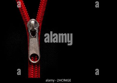 Close-up of the zipper on black clothing. Zipper with lock. Fabric with zipper Stock Photo