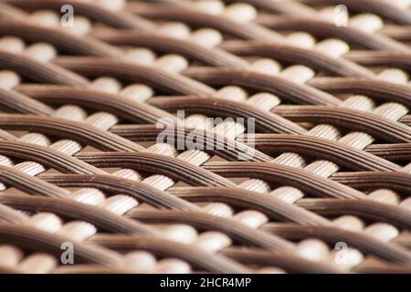 Selective focus shot of a Plastic rattan weave pattern for background texture Stock Photo