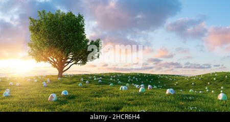 Many colorful painted Easter eggs are looking at meadow with tree for Easter, copy space for individual text Stock Photo